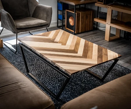 Wood herringbone pattern coffee table with welded metal base.