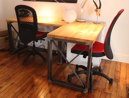 L shaped industrial desk with metal base and wood top